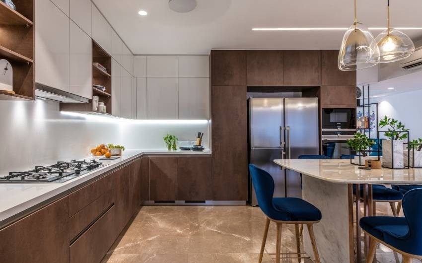 Wooden textured modular kitchen design with a breakfast counter - Beautiful Homes