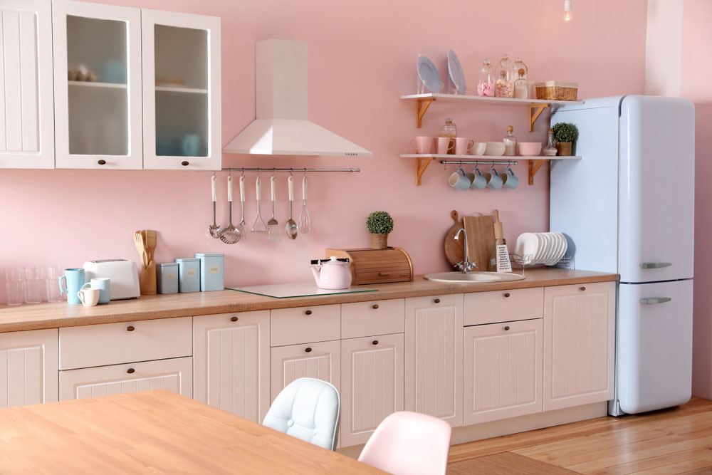 Pastel pink colour for the modular kitchen interiors with cream coloured kitchen cabinets - Beautiful Homes