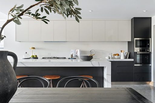 Parallel modular kitchen with black cabinets below the counter & white on the top - Beautiful Homes