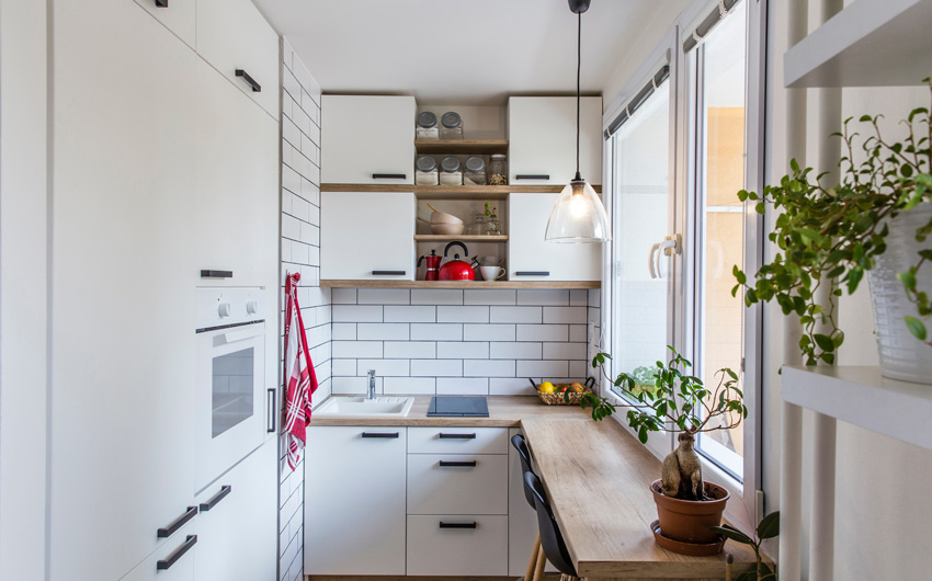 Scandinavian-styled mini modular kitchen in simple white and wood with potted plants