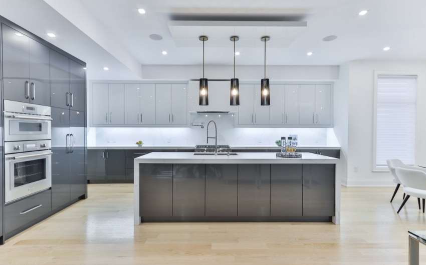 Monochromatic modular kitchen design with kitchen island & bright kitchen lighting - Beautiful Homes