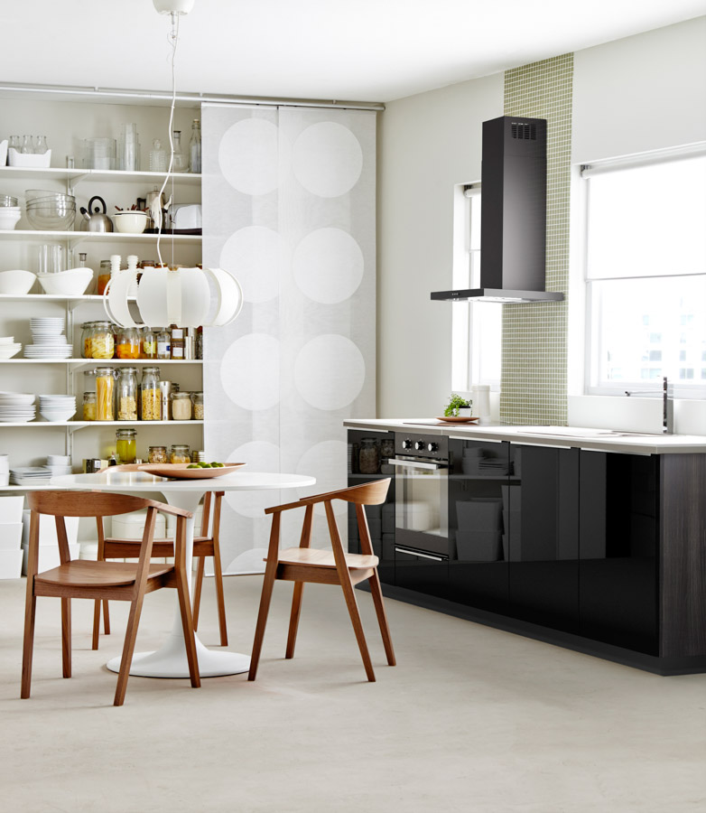 Open kitchen interior design in black tones, cupboard and table in white shades and brown wooden chairs - Beautiful Homes