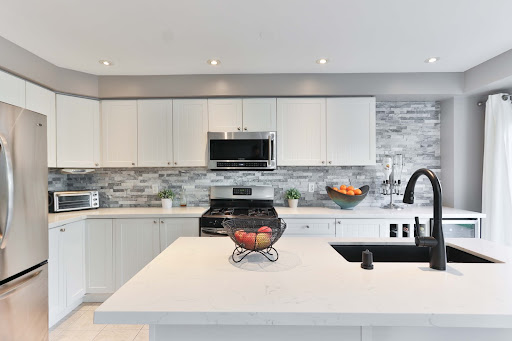 Monochromatic kitchen tiles wall for this white kitchen design - Beautiful Homes