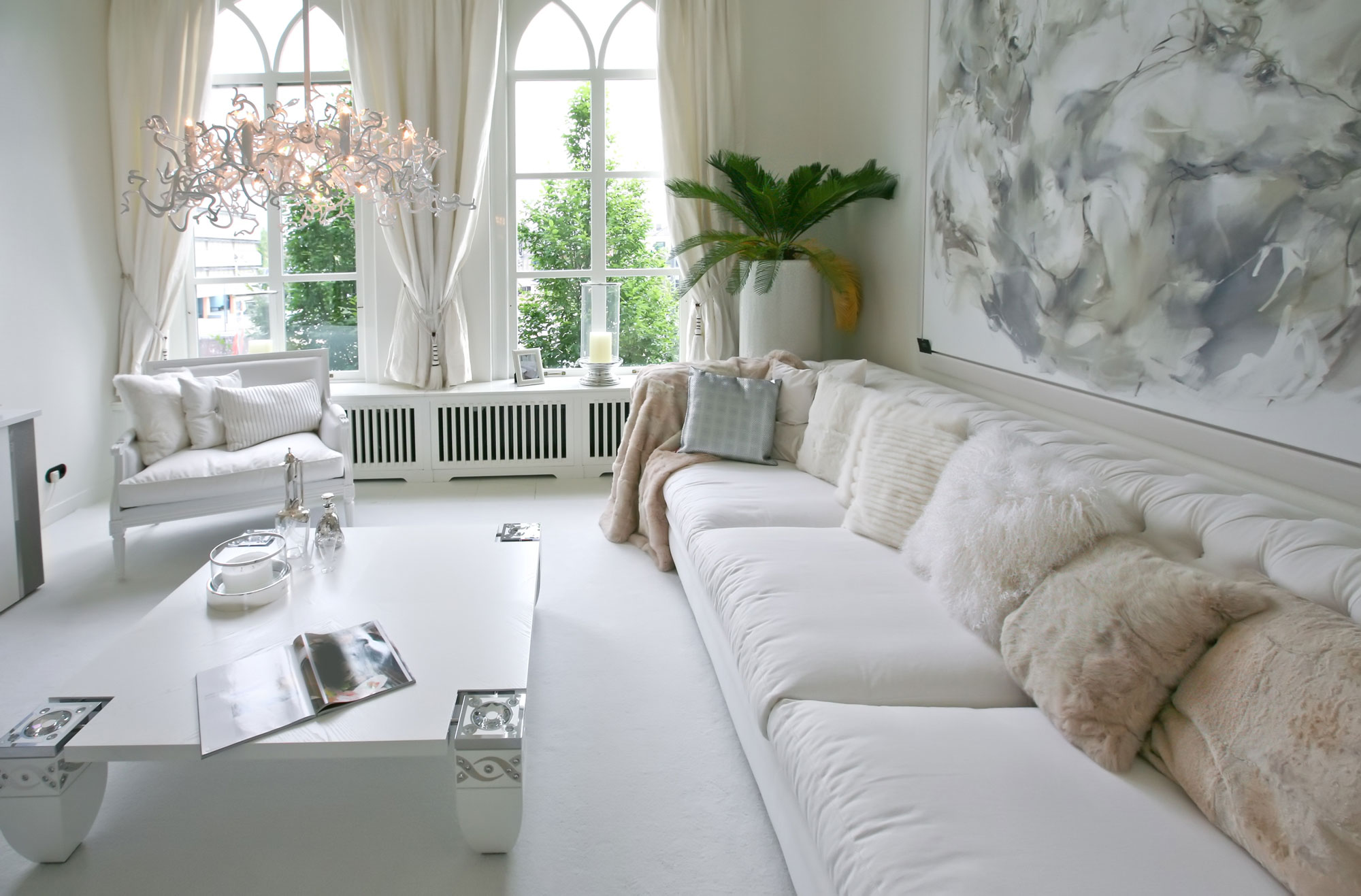 White Living Room Design Ideas With Tufted Sofa & Pale Pink Crystal Chandelier - Beautiful Homes