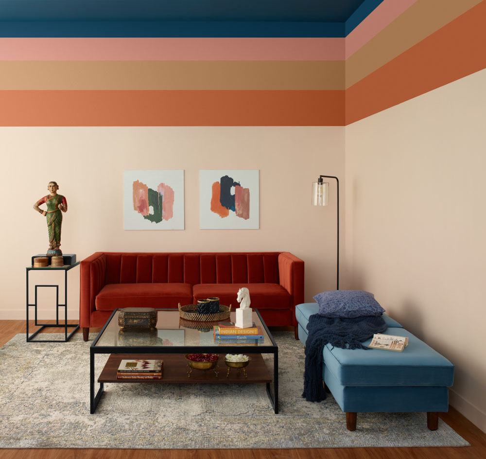 Living room with multi-hued colour palette with burnt sienna sofa colour - Beautiful Homes