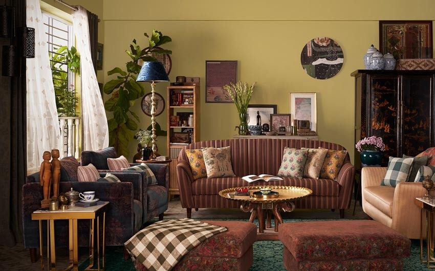 Yellow living room with a striped sofa chairs with floral fabric