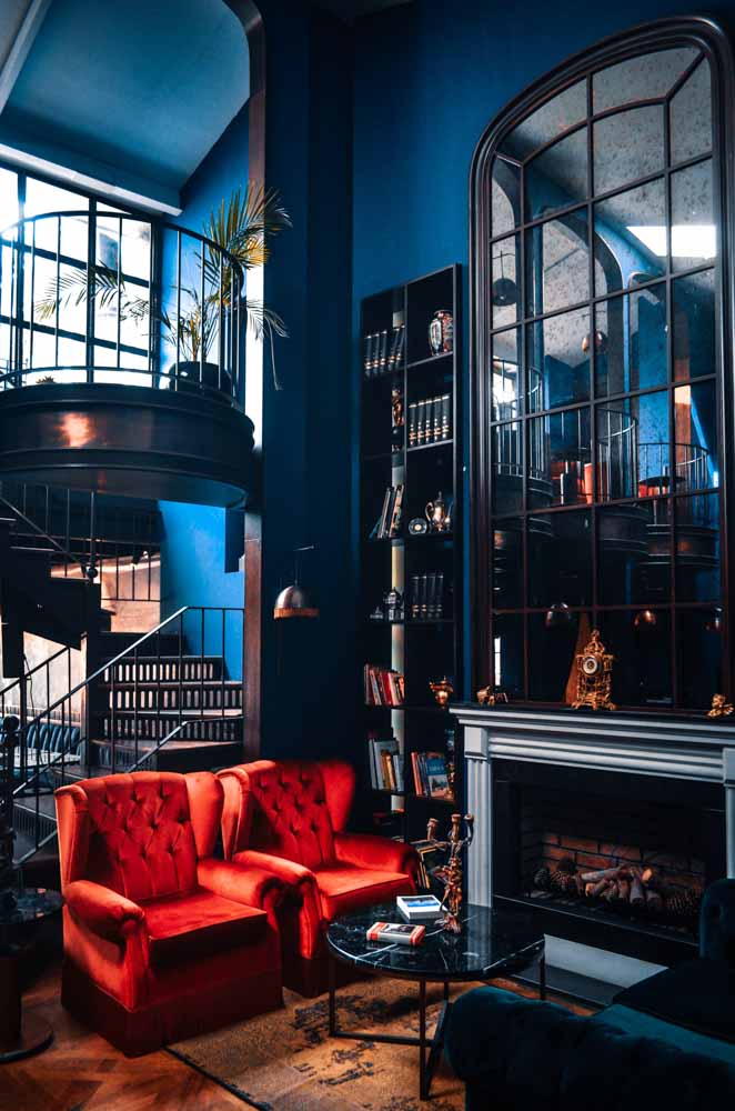 Fireplace having tall mirror placed over it for double height ceiling  living room - Beautiful Homes