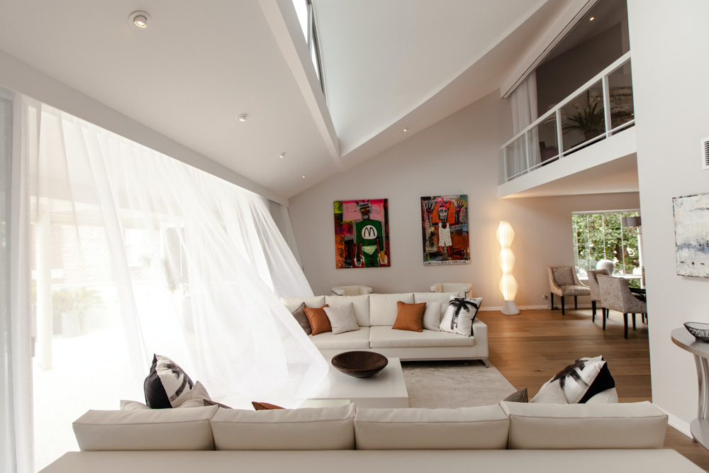 Modern double height ceiling with skylight for the perfect living room interior - Beautiful Homes