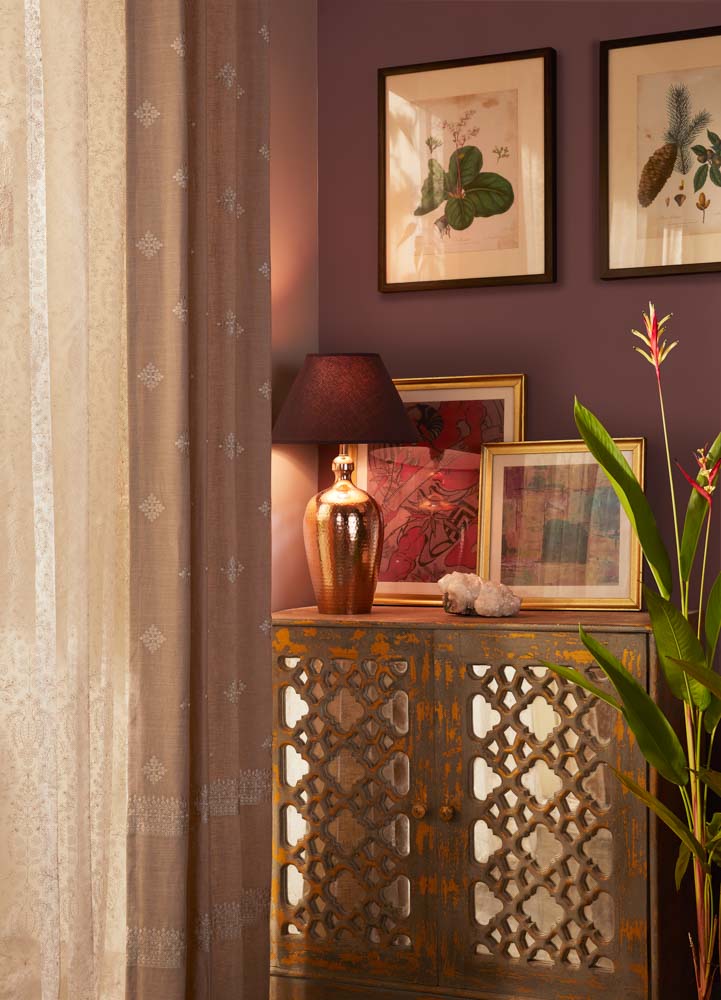 A cabinet with a couple of frames placed on it