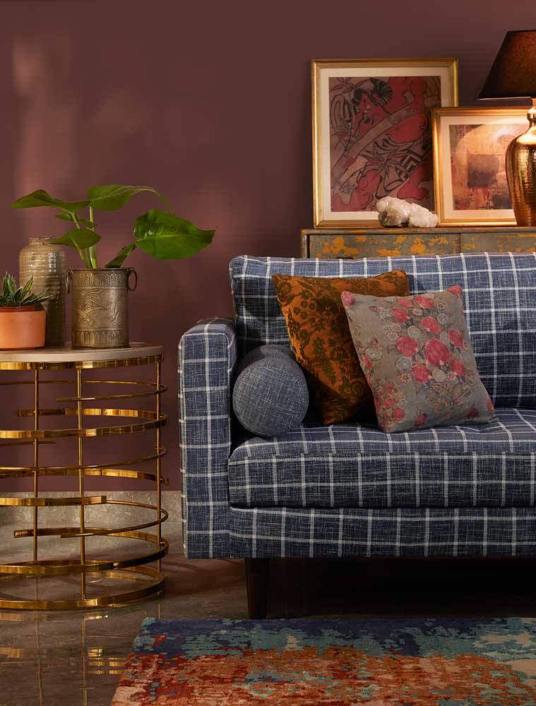 A blue sofa with a side table beside it