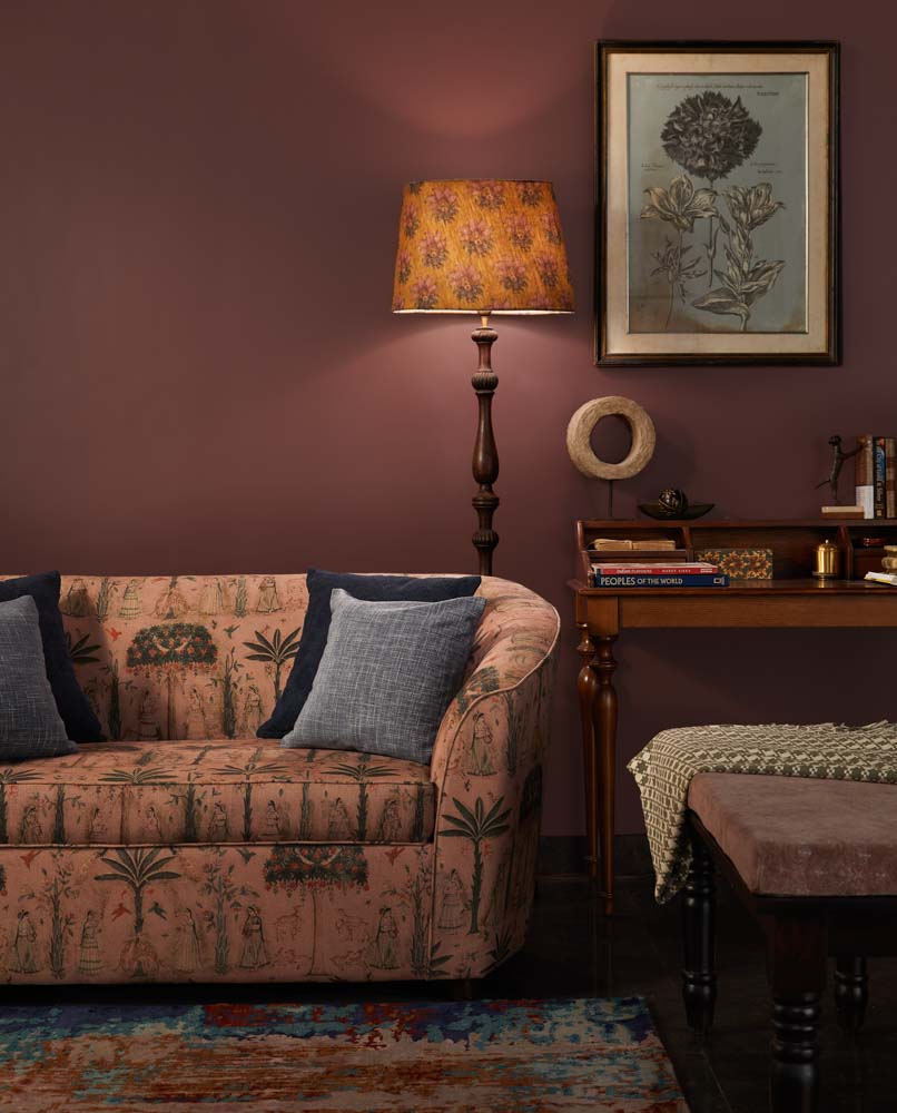 A two seater sofa with a wooden table beside it