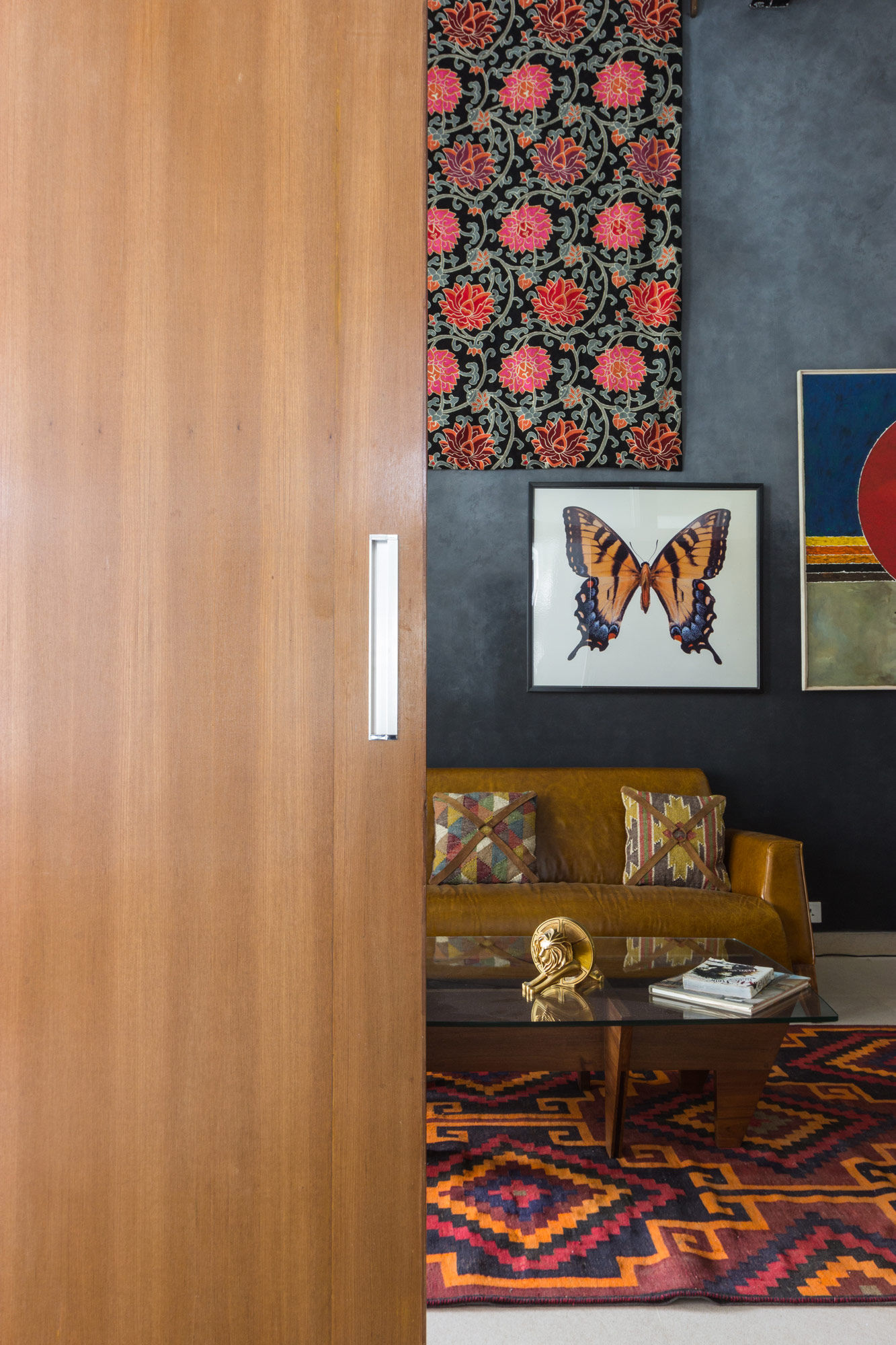 A personal space with dark teak furniture and leather accents - Beautiful Homes