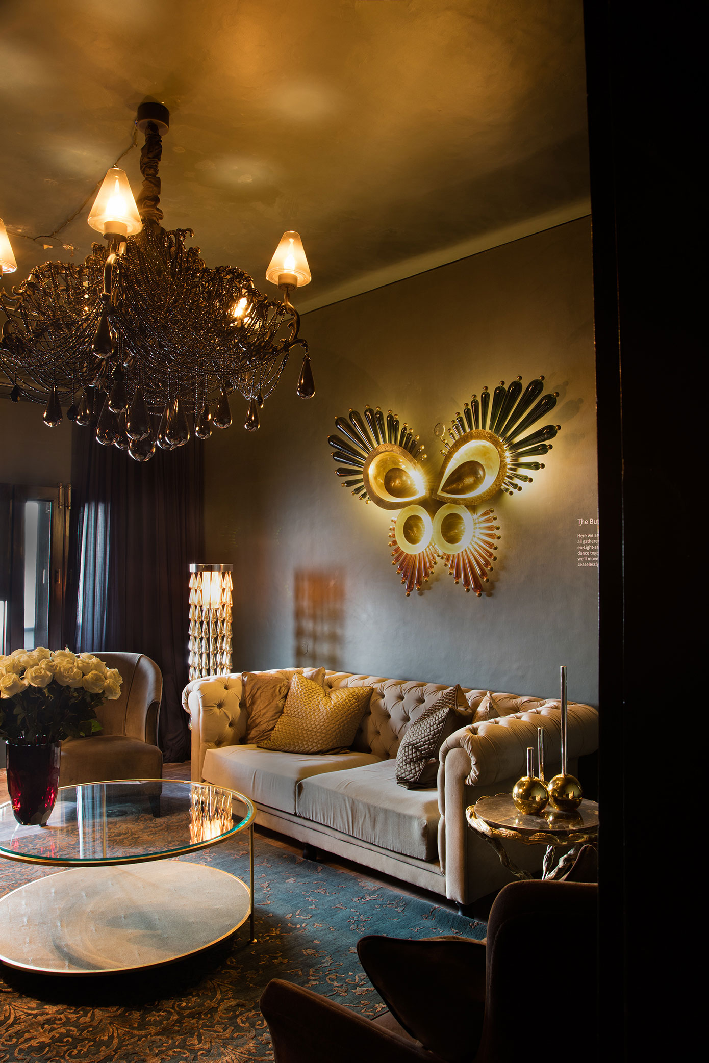 A Butterfly wall mural made of brass and hand blown glass in the living room - Beautiful Homes