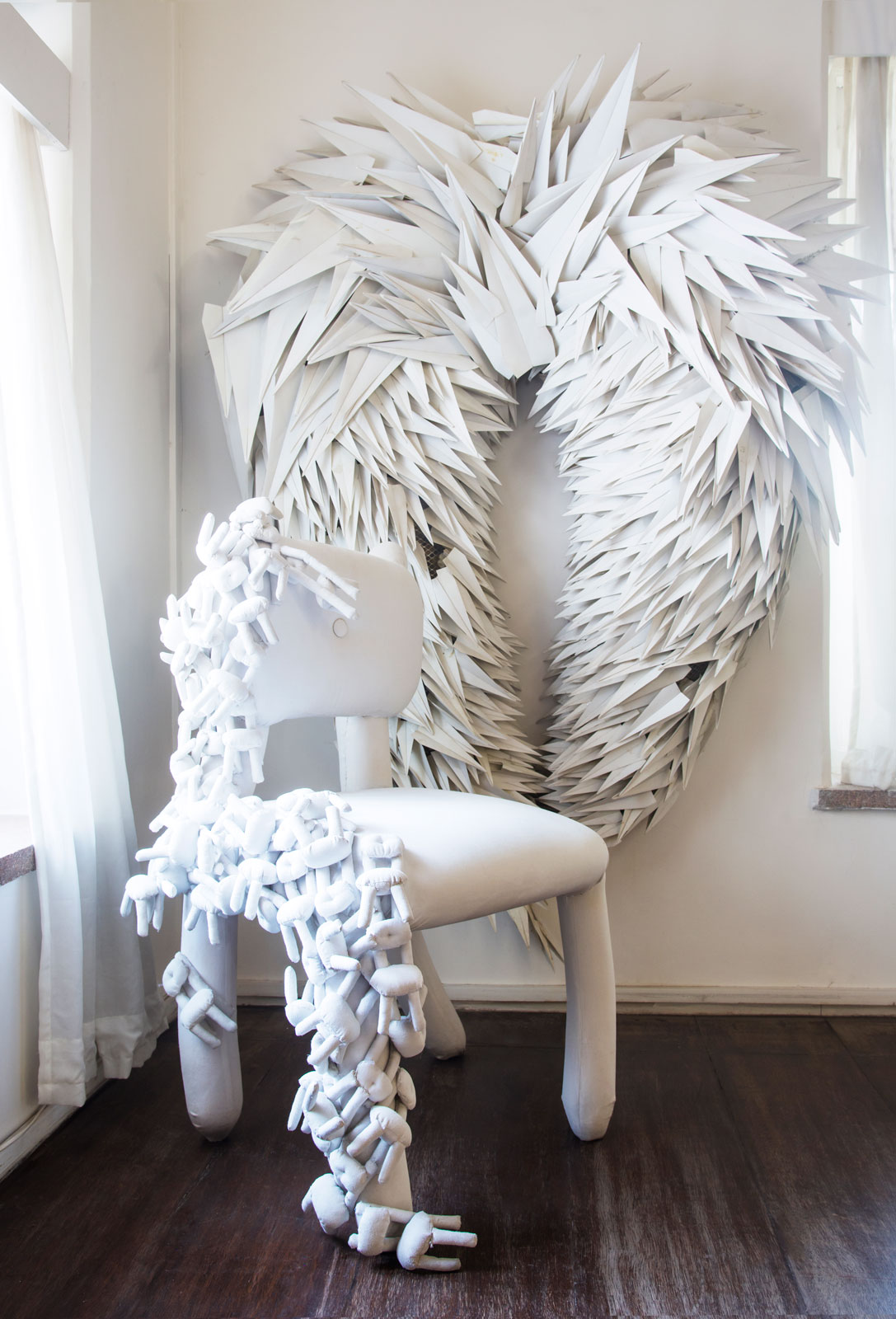 A part of the chair is created by Lekha Washington and decorated with mini chairs by Jean Francois - Beautiful Homes