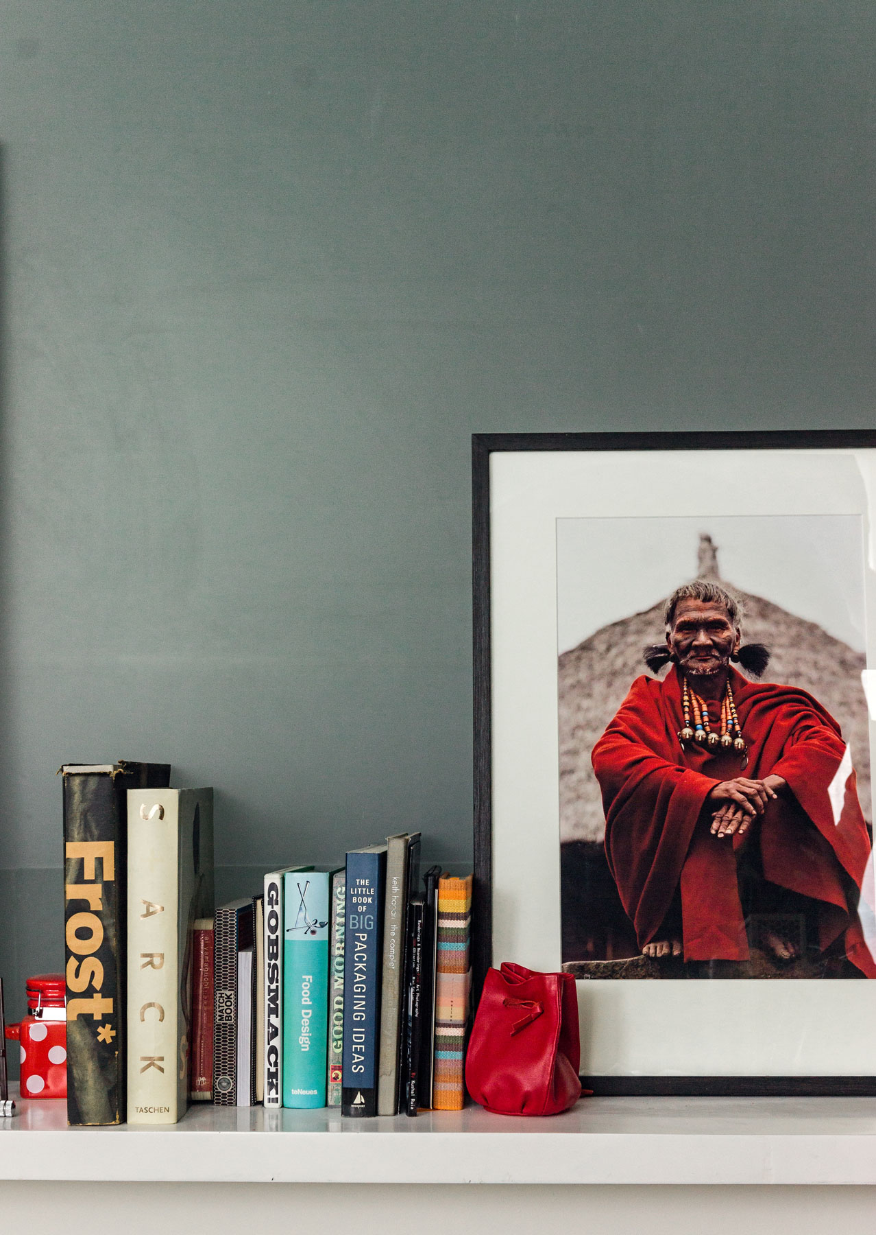 Photo prints from the trip to the North East of India occupy one side of the shelves - Beautiful Homes