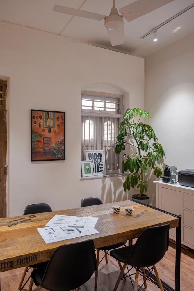 Art prints, plants and a Nespresso machine make up a casual meeting room - Beautiful Homes
