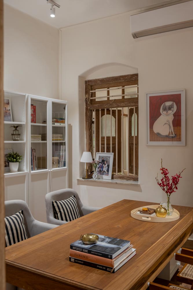 The private cabin has a private desk, coffee table, books & studio decor - Beautiful Homes
