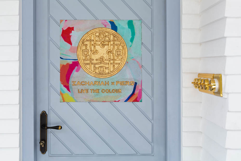 Main door with pastel blue colour features a tile embossed with the studio's colourful logo - Beautiful Homes