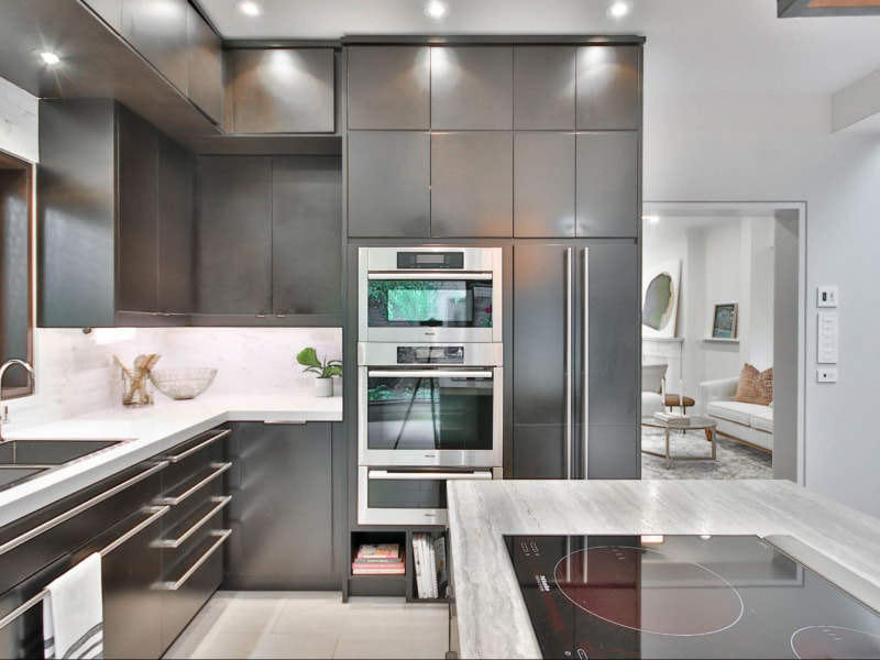 Monochrome kitchen interiors with black stainless steel appliances - Beautiful Homes