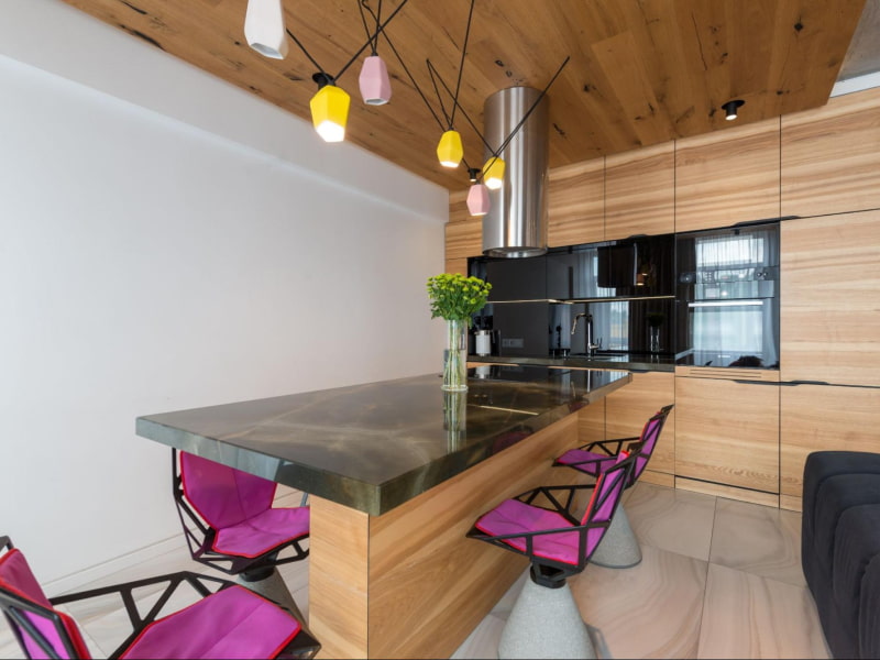 Wooden kitchen design with black stainless steel appliances & countertop - Beautiful Homes