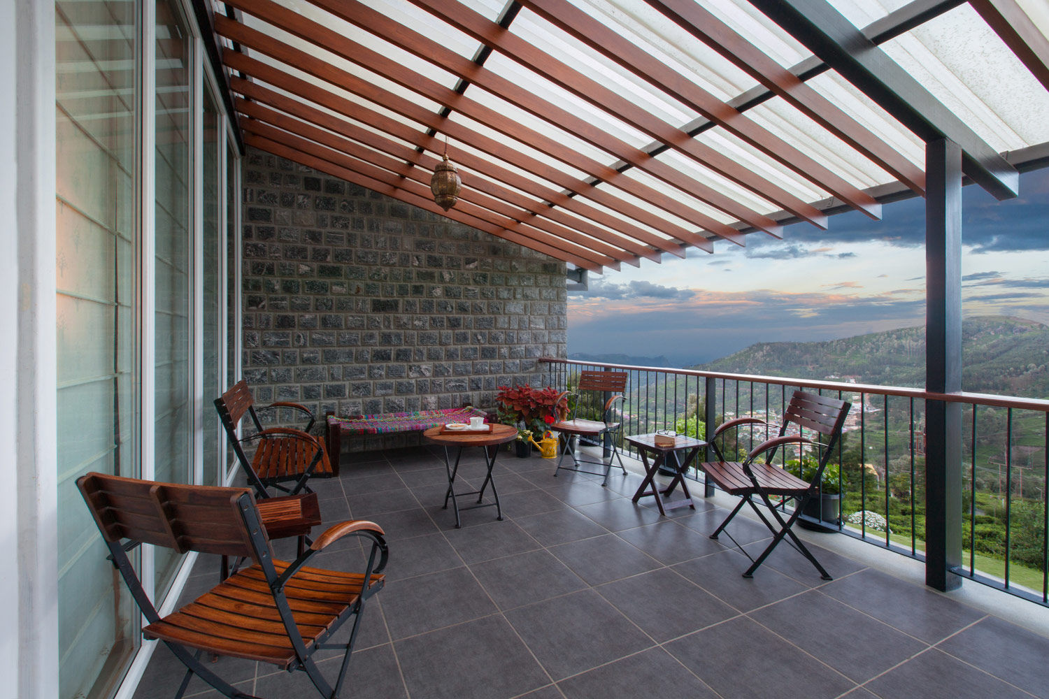 A balcony with wooden chairs and a small table - Beautiful Homes